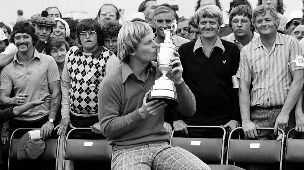 Johnny Miller kisses the British Open Golf trophy after winning the 1976 title at the Royal Birkdale golf course in Southport, England. In 2018, Miller returned to Royal Birkdale for the first time in 26 years as the lead analyst for NBC